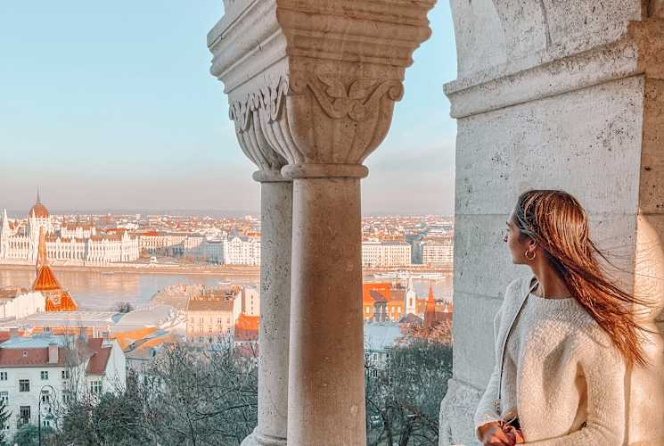 A student looking out towards a view of Budapest.